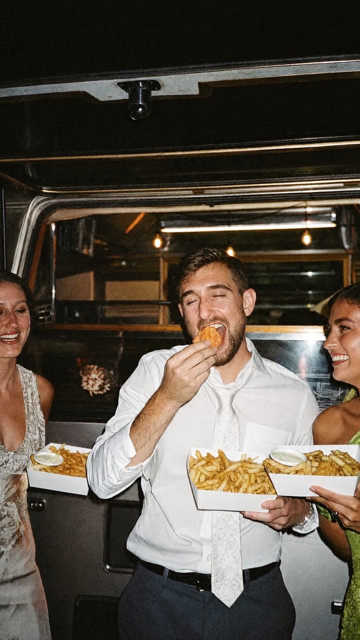 Een gast eet friet bij de snackkar, laat op de avond