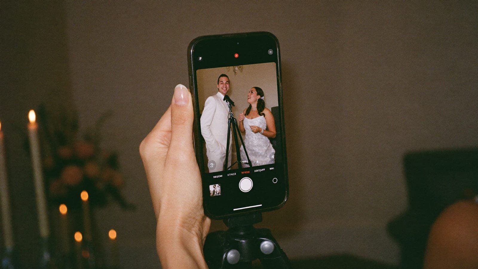 Een telefoon op een statiefje neemt een videoboodschap voor het bruidspaar op