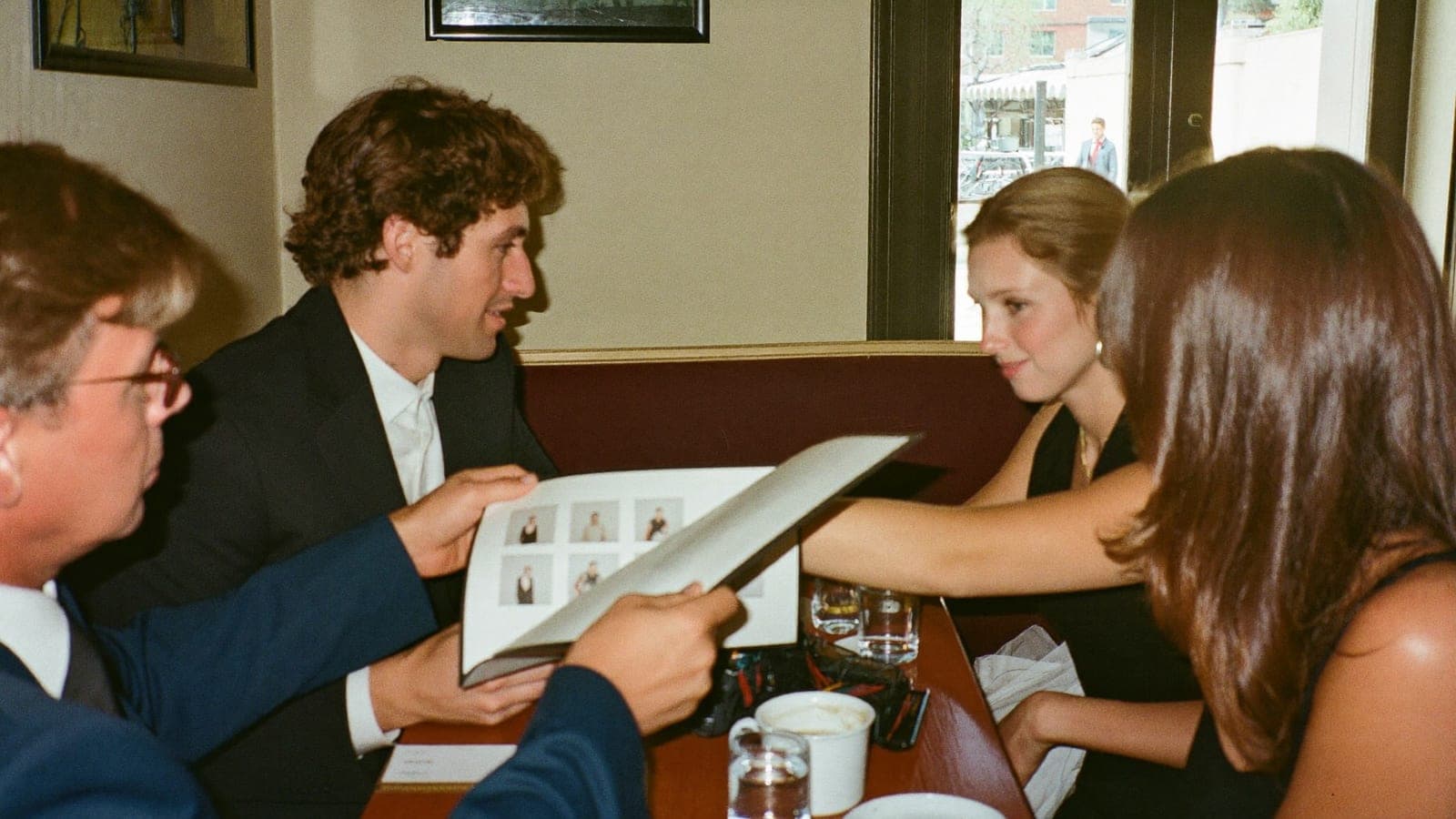 Een stel bekijkt in een café het portfolio van een trouwfotograaf